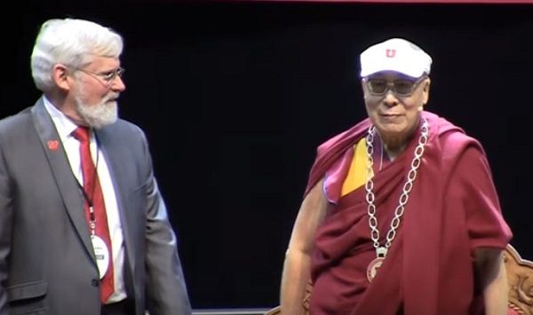 His Holiness Dalai Lama dons a University of Utah visor and honorary medal.