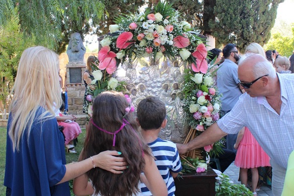 Children, adults, elderly people and people with serious illnesses stand in long queues, some for hours hours in order to pray before the icon of the Assumption of Mary. Some of them. leave candles on the foot of the icon stand.