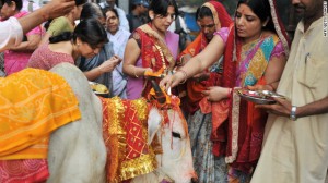 Hindu devotees worship a sacred cow on the eve of Gopastami in Hyderabad on November 3, 2011. The cow is regarded by Hindus as <i>gau mata</i>, or maternal figure, and has had a long-standing central role in India's religious rituals.
