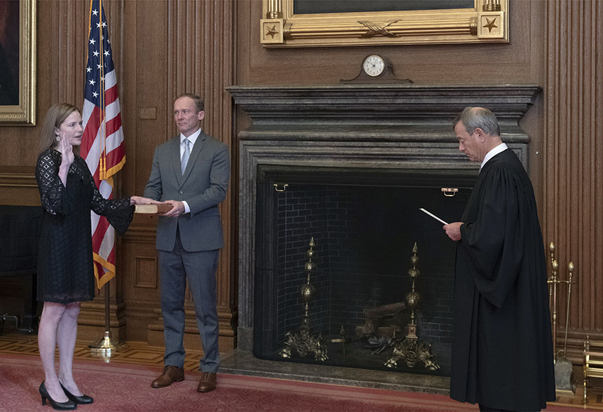 Chief Justice John G. Roberts, Jr., administers the Judicial Oath to Judge Amy Coney Barrett in the East Conference Room, Supreme Court Building. Judge Barrett’s husband, Jesse M. Barrett, holds the Bible. Credit: Fred Schilling, Collection of the Supreme Court of the United States