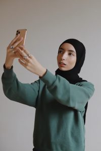 Muslim girl with phone unsplash