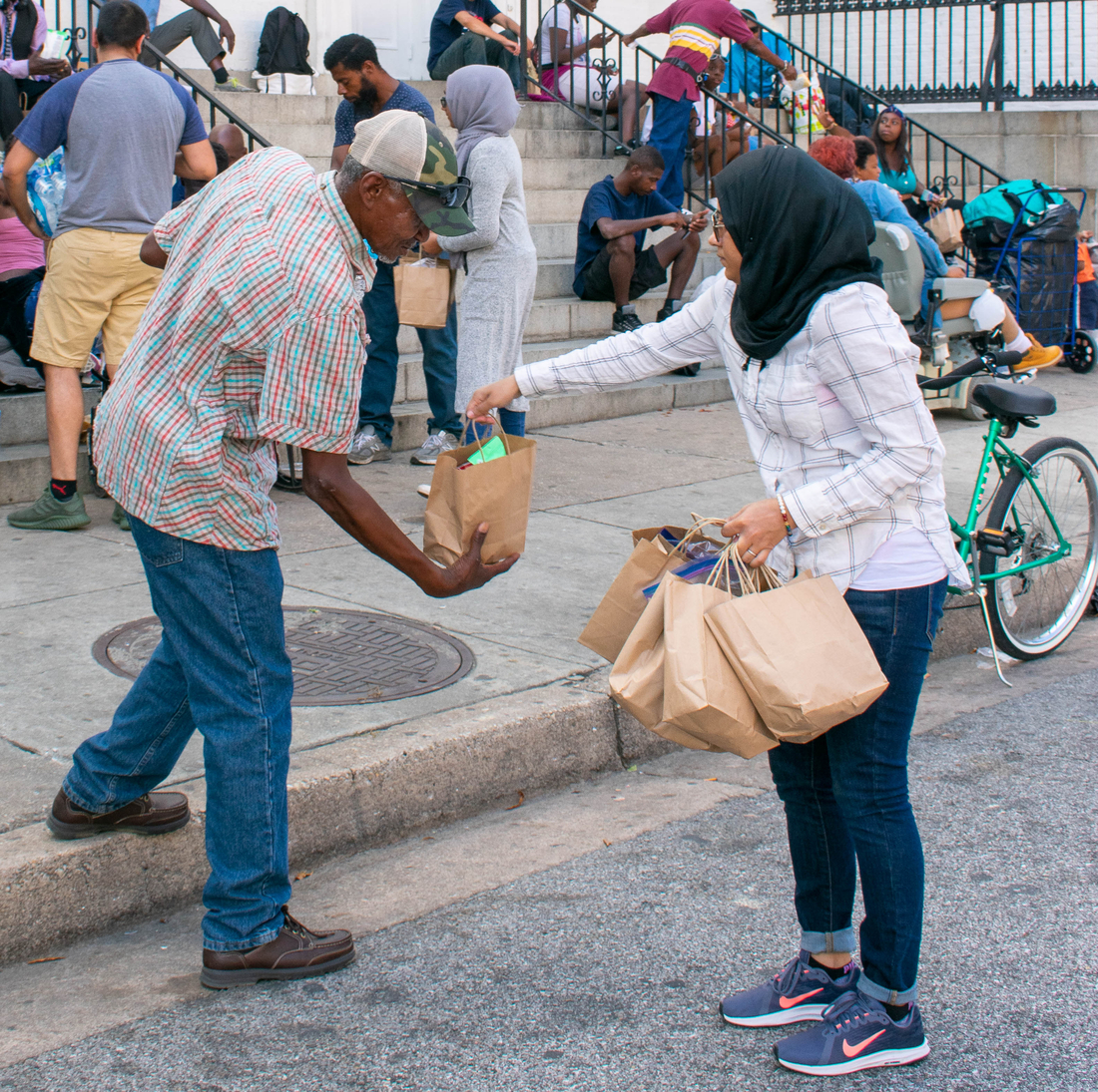 Act of Kindness Homeless Care Package Muslim Woman Hijabi Homeless Man at the steps of a Church