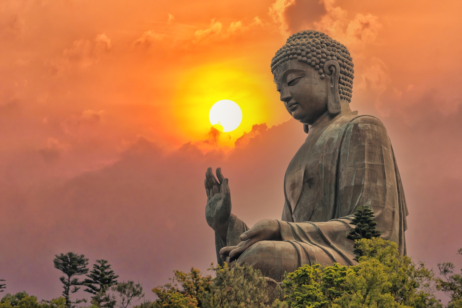 Big bronze Amoghasiddhi Buddha statue called Tian Tan Buddha with sunset sky at Po Lin Monastery Ngong Ping in Lantau Island famous tourist destination in Hong Kong China