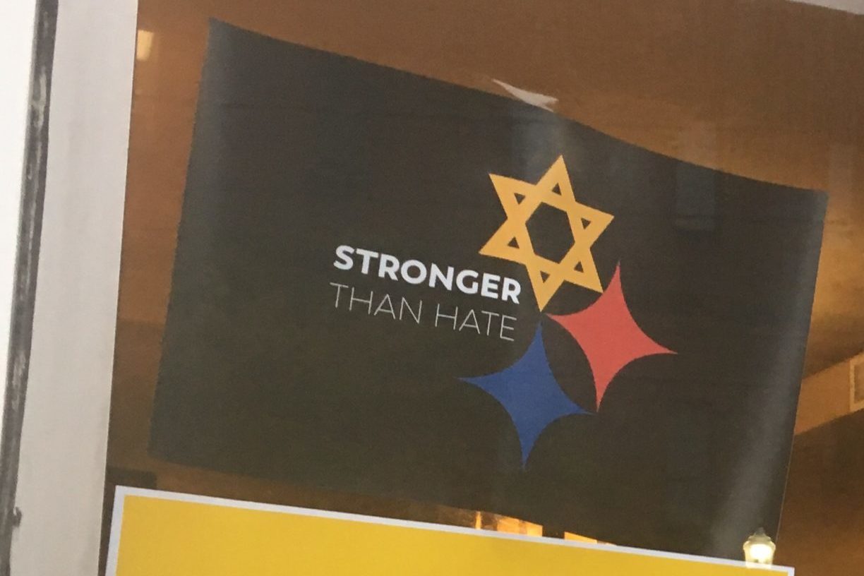 Posters on the window of a coffee shop on Murray Avenue at Squirrel Hill, in response to the Pittsburgh synagogue shooting.