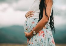 Pregnant lady holding belly. Free public domain CC0 photo.