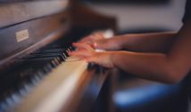 person playing upright piano