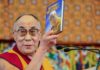 Man holding Beyond Religion book