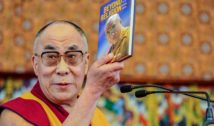 Man holding Beyond Religion book