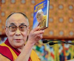 Man holding Beyond Religion book
