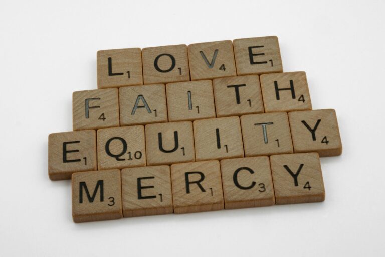 scrabble tiles spelling love, faith, equality, and mercy