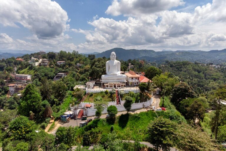 Gautama Buddha statue under white clouds